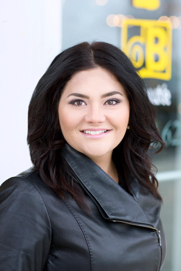 heasdshot of salon owner Dalena Buchman in front of beauty parlor